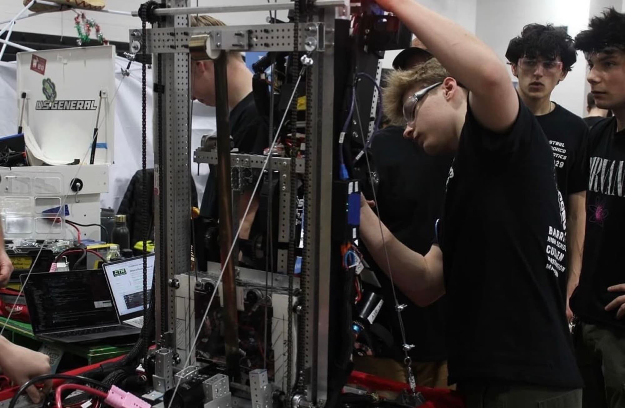 Steel Bronco students working together on the robot in the pit